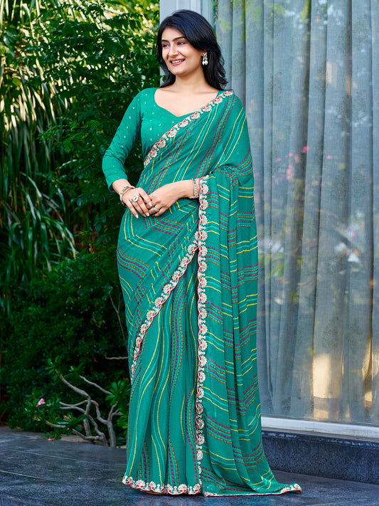 Woman wearing teal green georgette saree with striped pattern design and teal green blouse