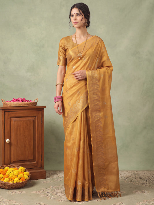 Woman wearing mustard linen saree with traditional indian motif work and mustard blouse
