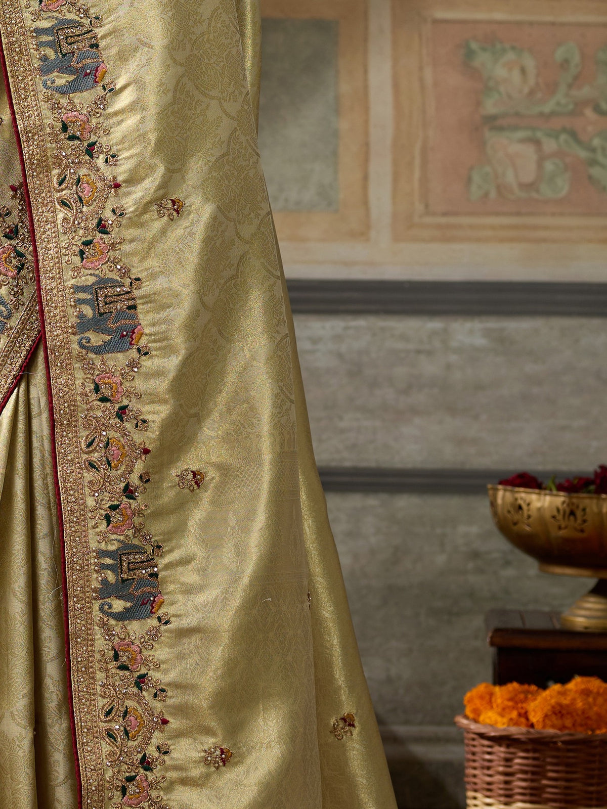 Pallu detail of gold silk blend saree showing ornamented surface design and embellished border