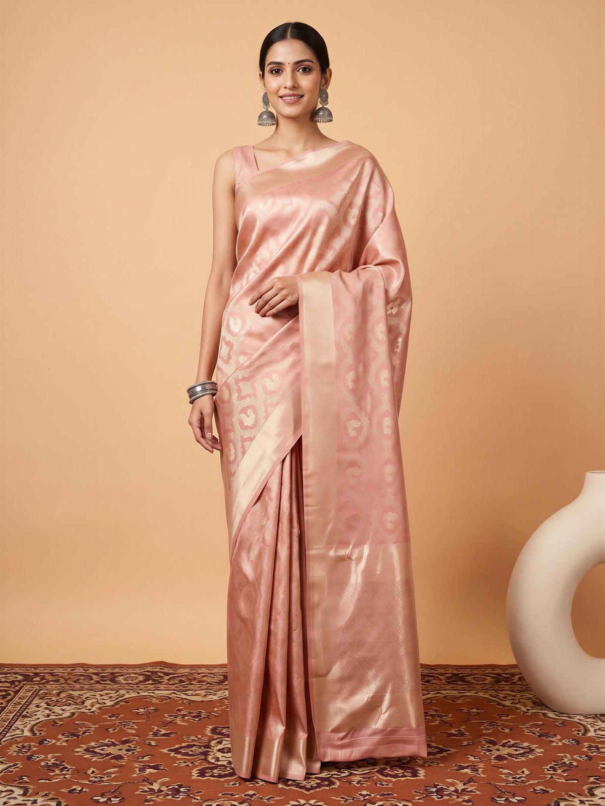 Woman wearing peach silk blend saree with woven motif design and peach blouse