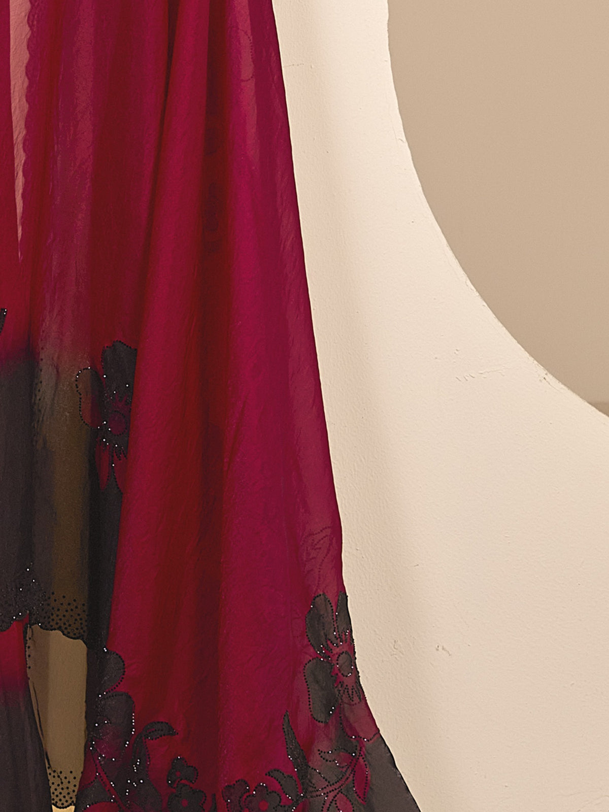 Pallu detail of red satin silk saree showing ornamented surface design and embellished border