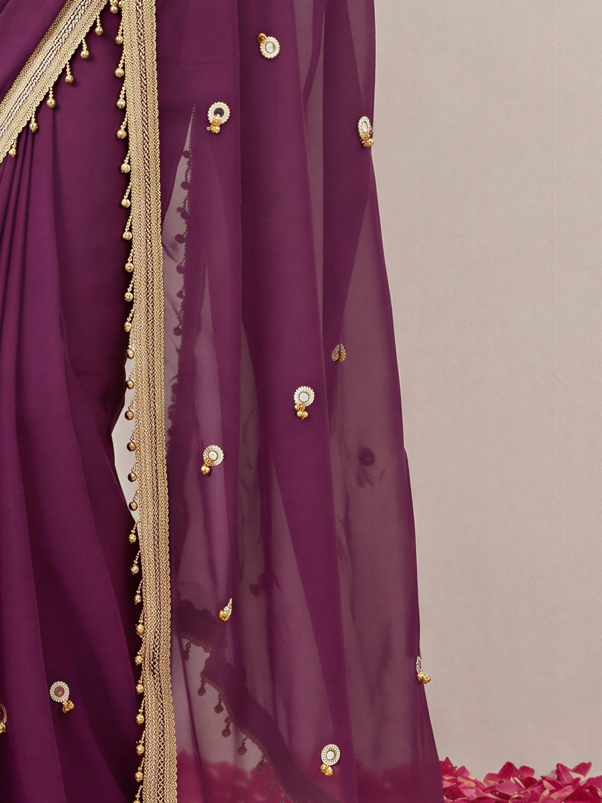Pallu detail of wine poly georgette saree showing ornamented surface design and embellished border