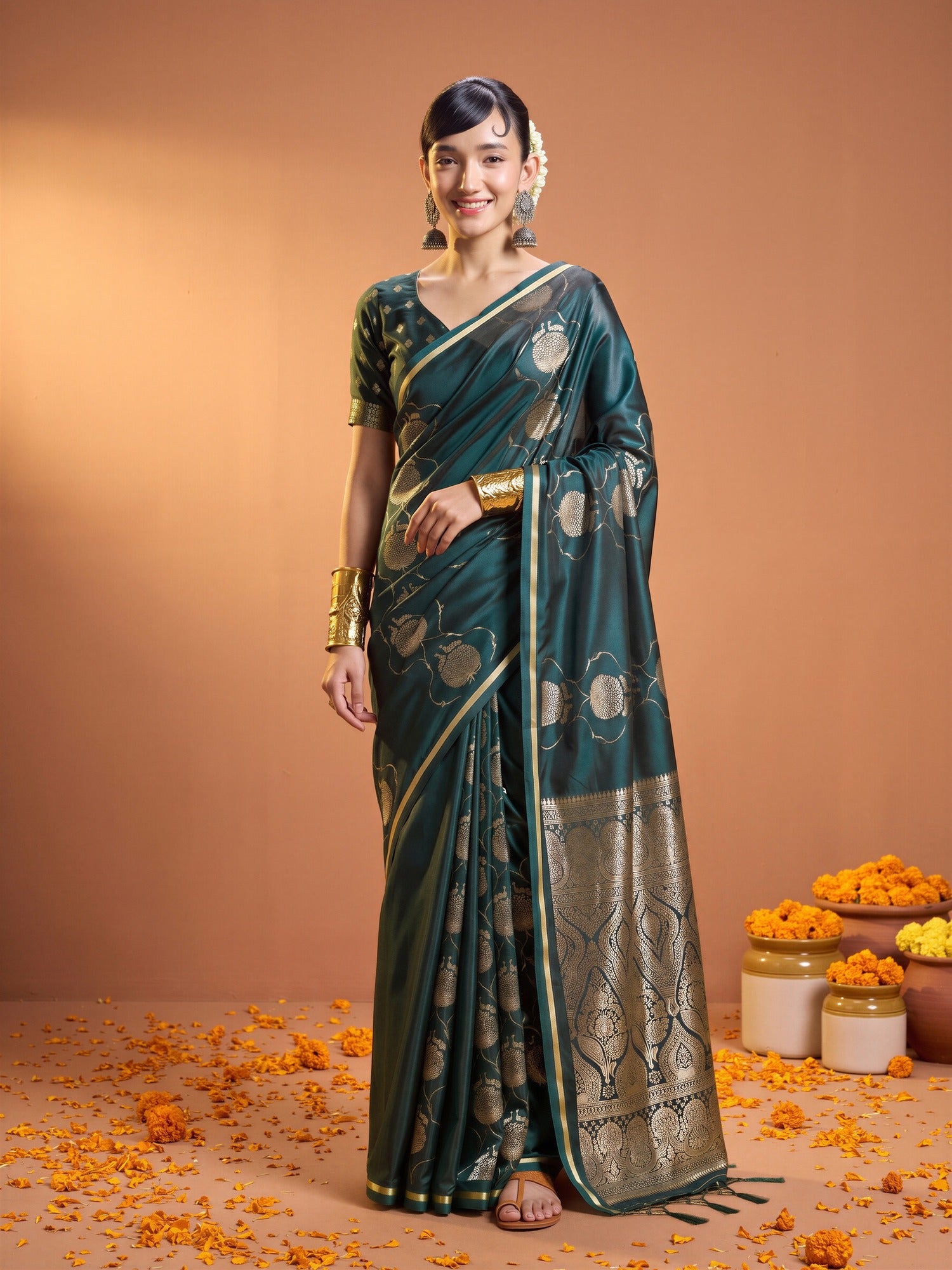 Woman wearing green satin saree with zari butta (metallic motif) work and green blouse