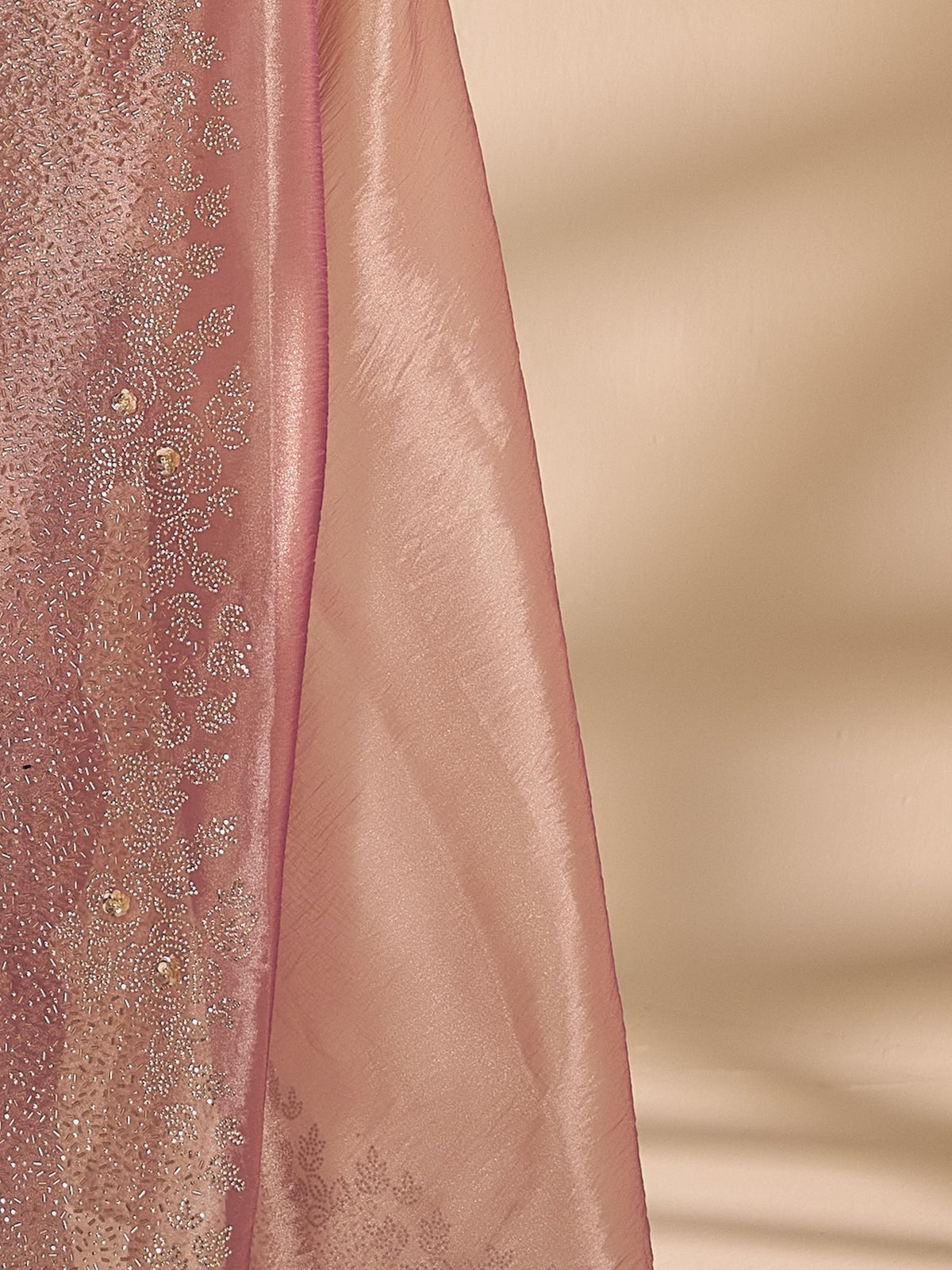 Pallu detail of mauve organza saree showing applique design and embellished border