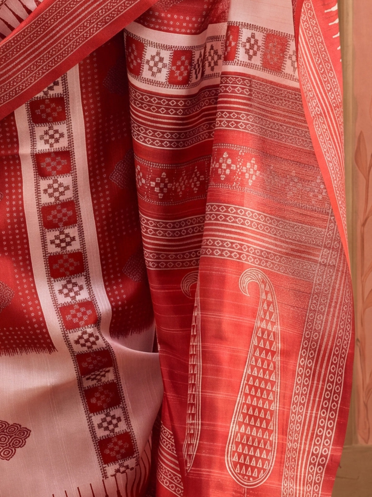 Pallu detail of beige bhagalpuri silk saree showing ikat resist-dyed pattern and printed border