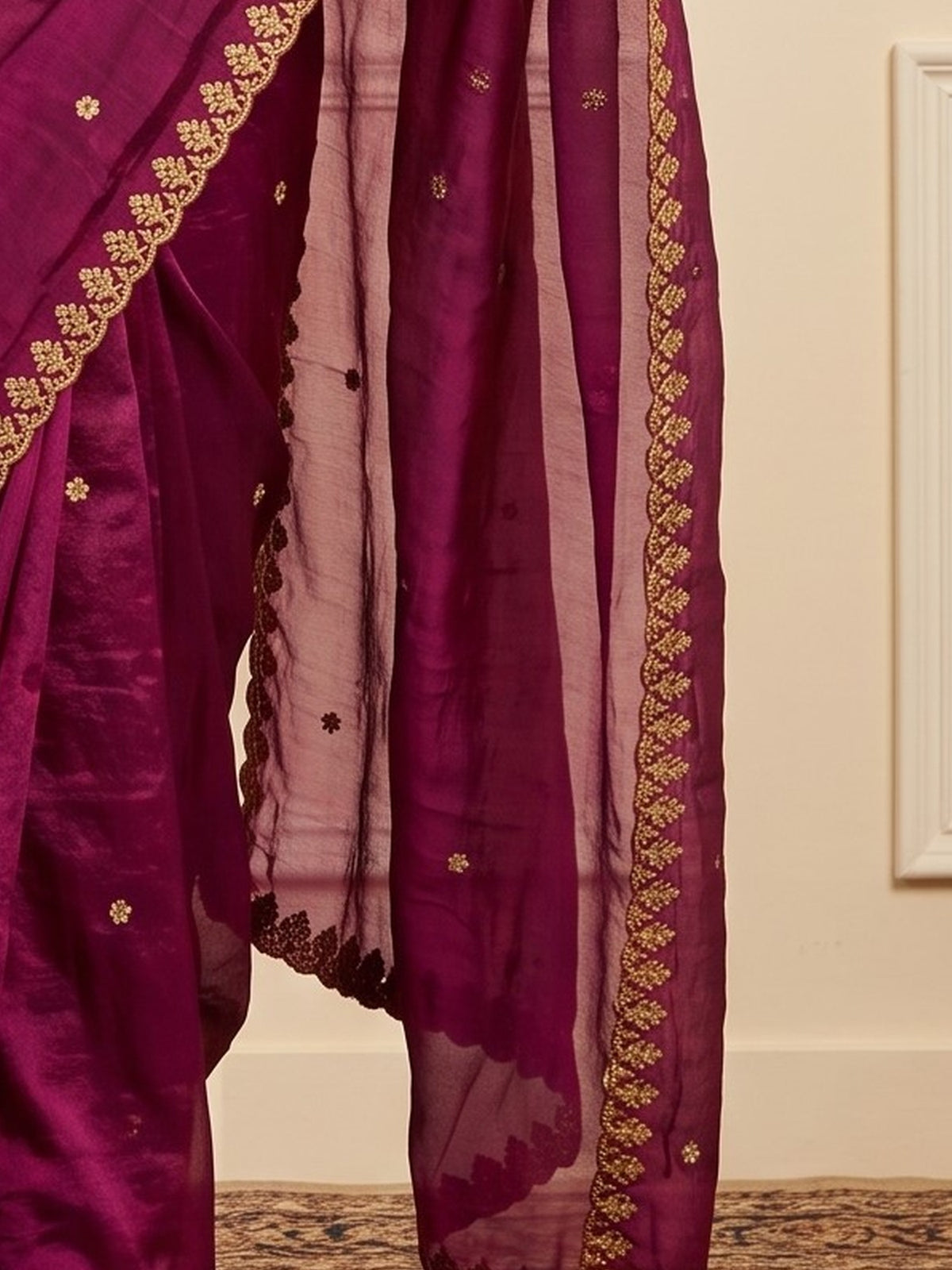 Pallu detail of magenta paper silk saree showing embroidered motif work and embroidered border