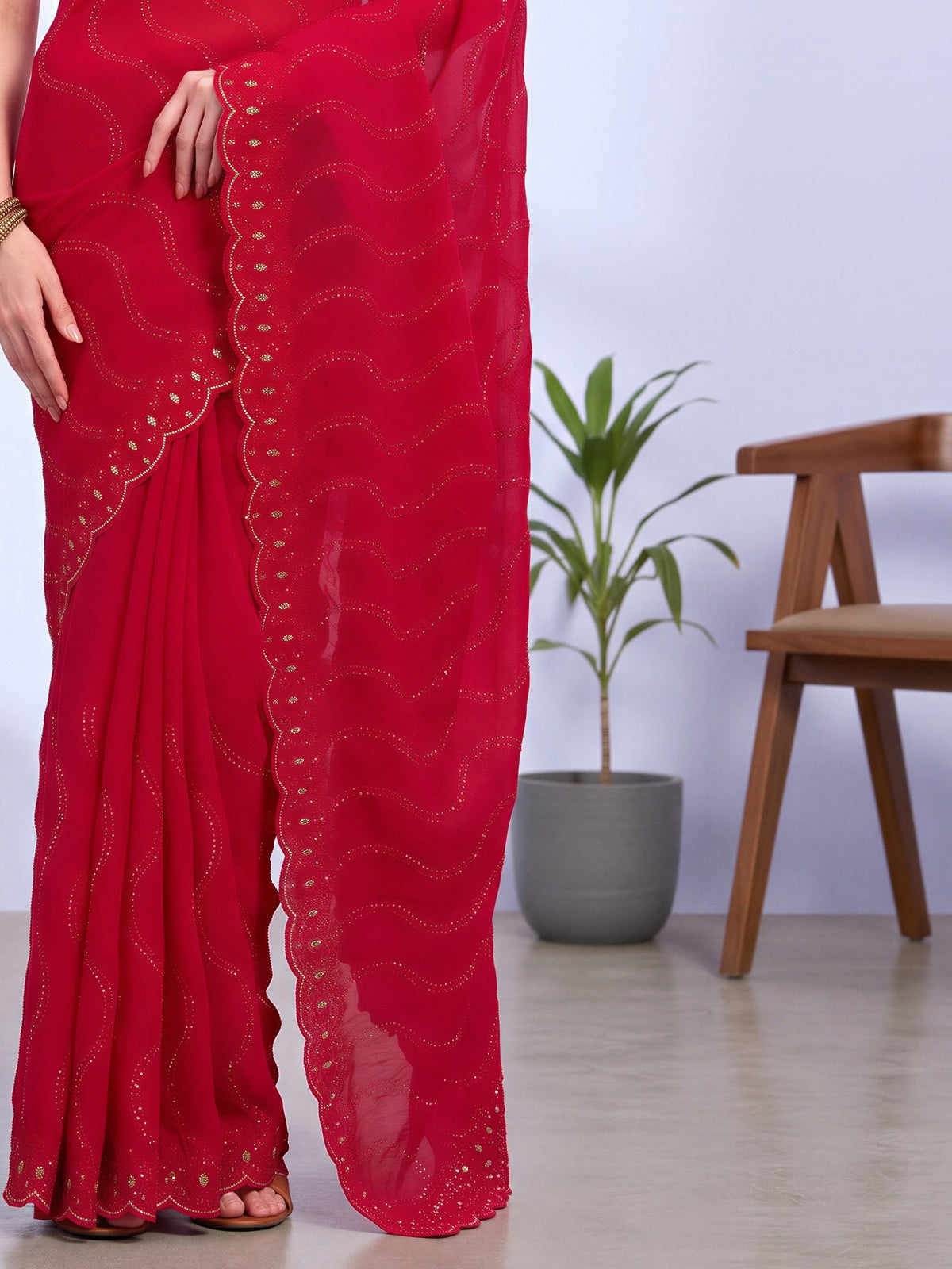 Pallu detail of red tissue saree showing geometric pattern design and embellished border