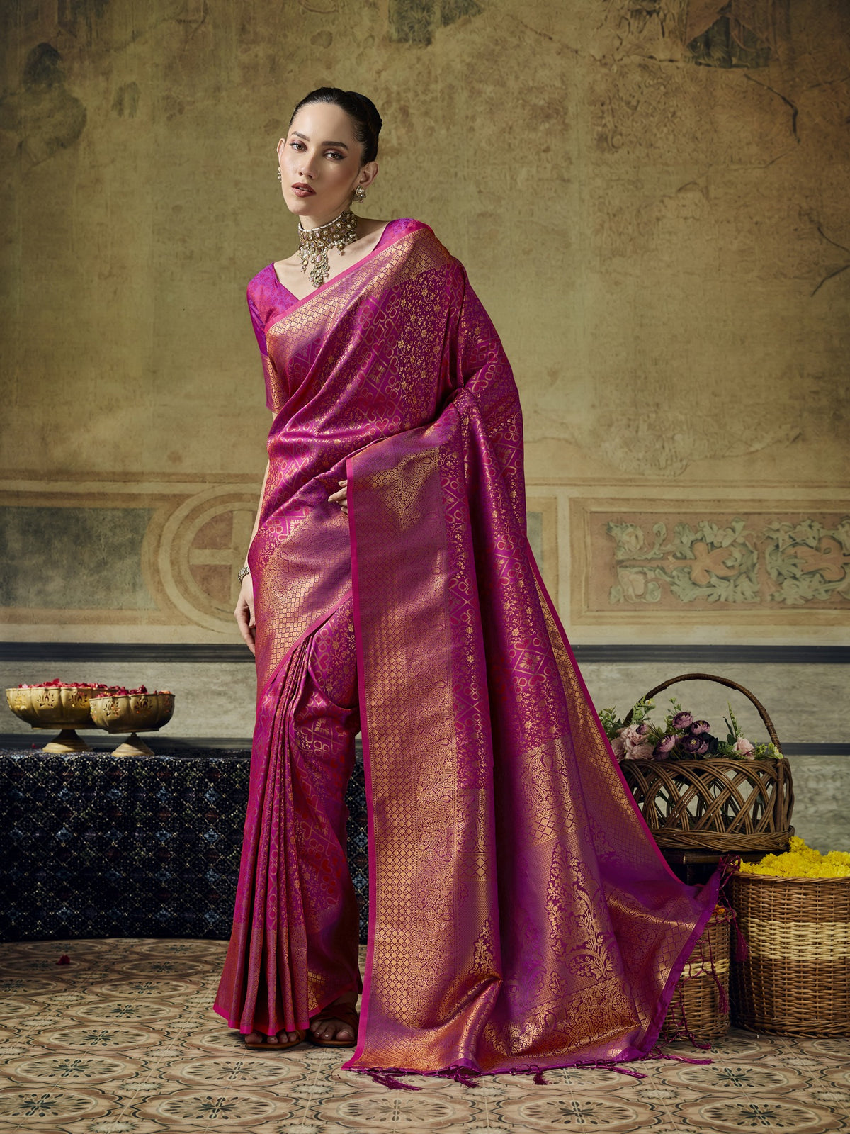 Woman wearing magenta pure silk saree with woven motif design and magenta blouse