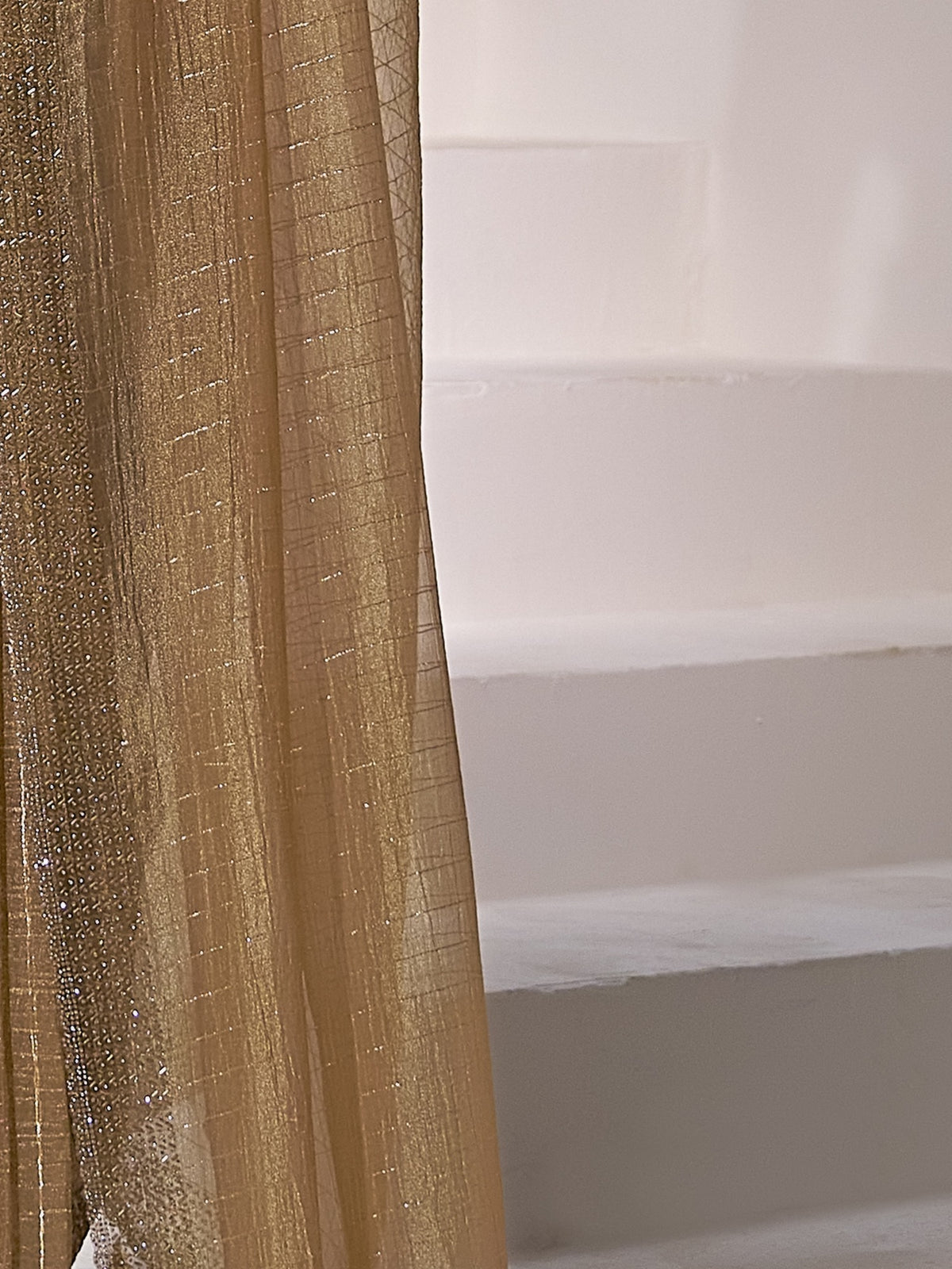 Pallu detail of mustard organza saree showing striped pattern design and embellished border