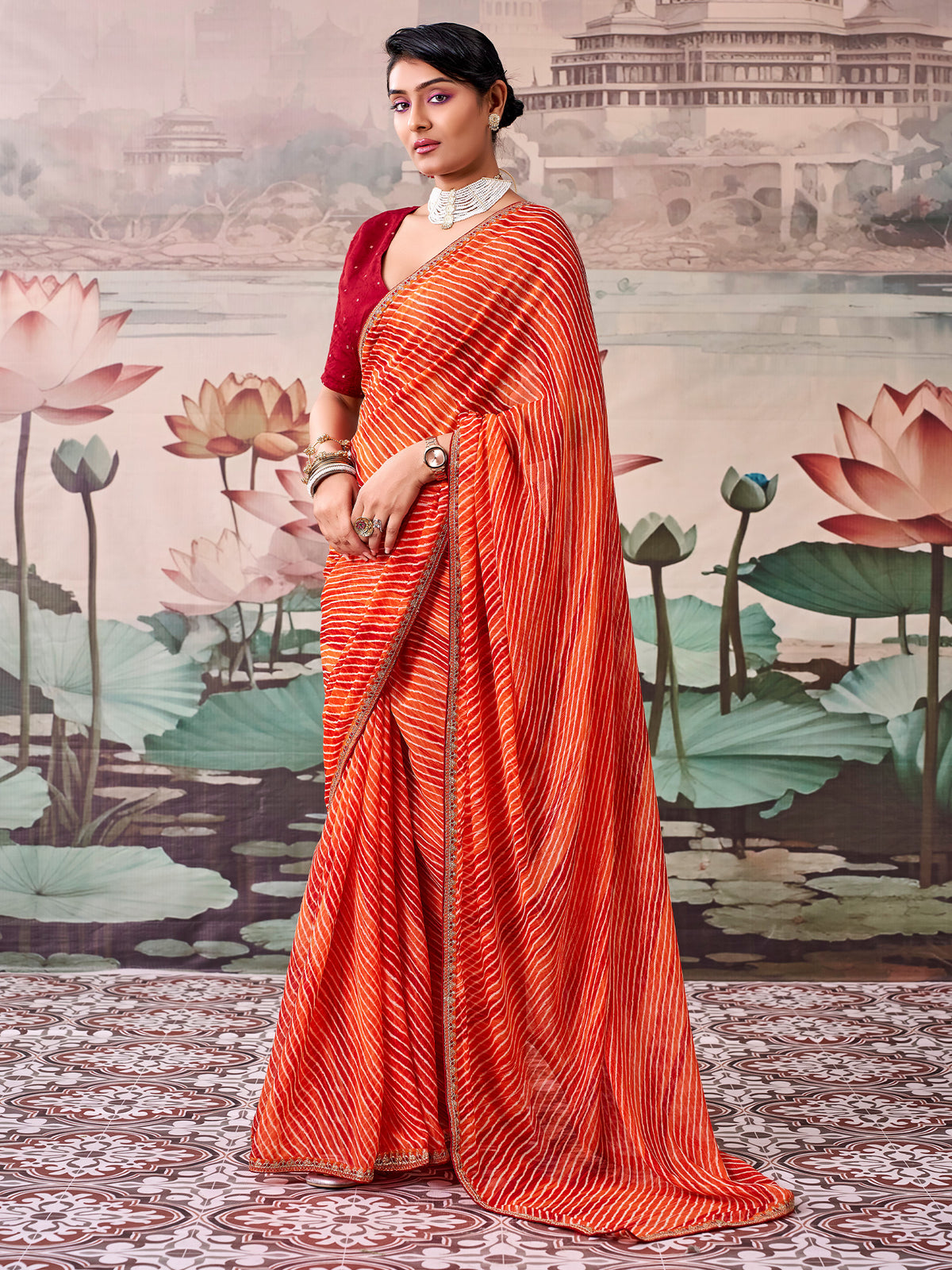 Woman wearing orange georgette saree with leheriya design and red blouse