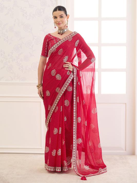 Woman wearing red chiffon saree with metallic foil print work and red blouse