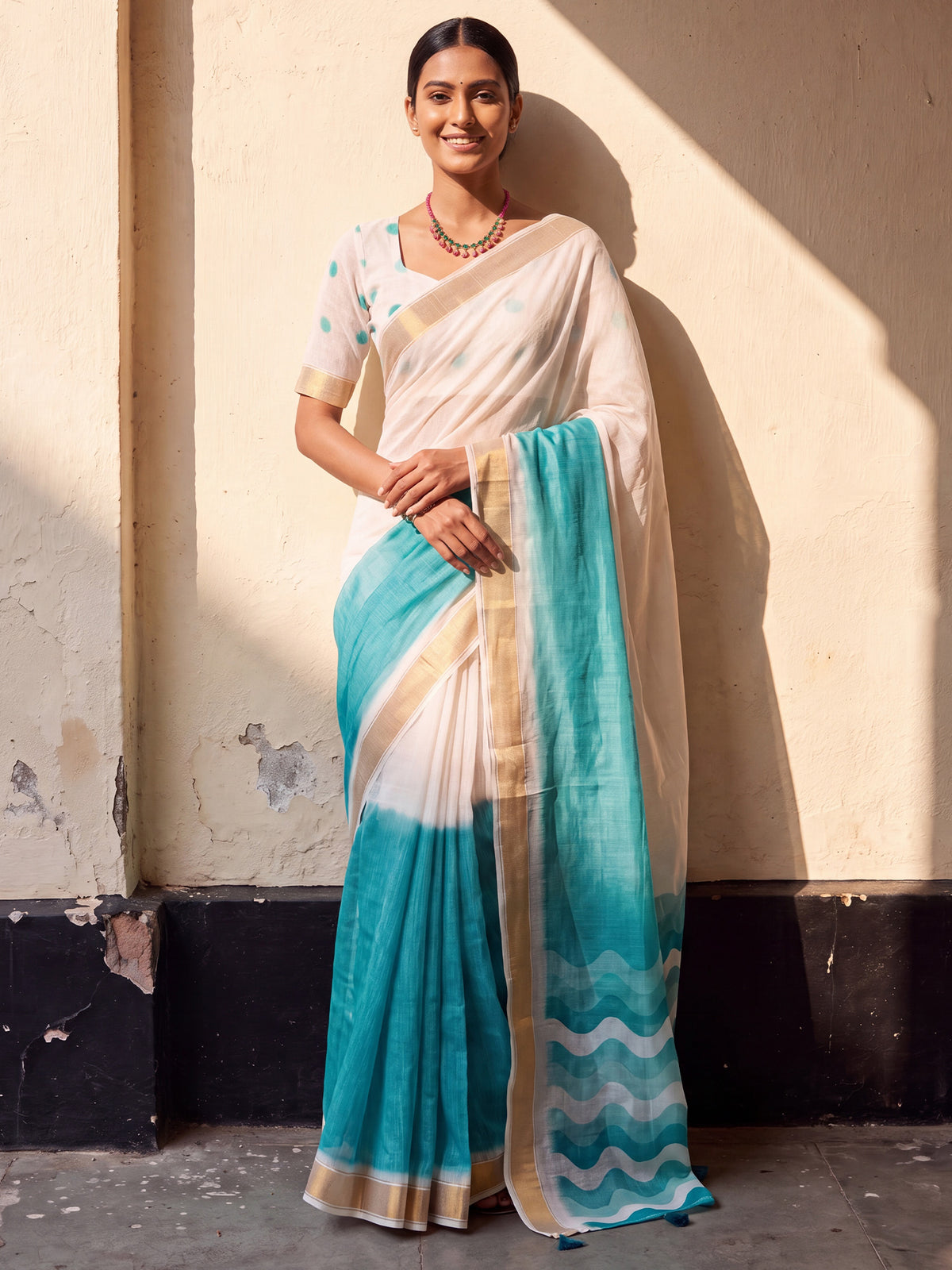 Woman wearing light blue linen saree with ombre graded colour work and white blouse