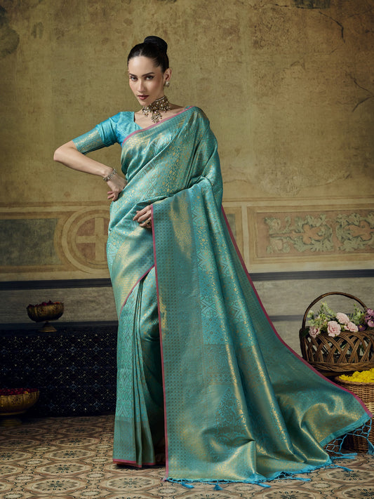 Woman wearing turquoise blue pure silk saree with woven motif design and turquoise blue blouse