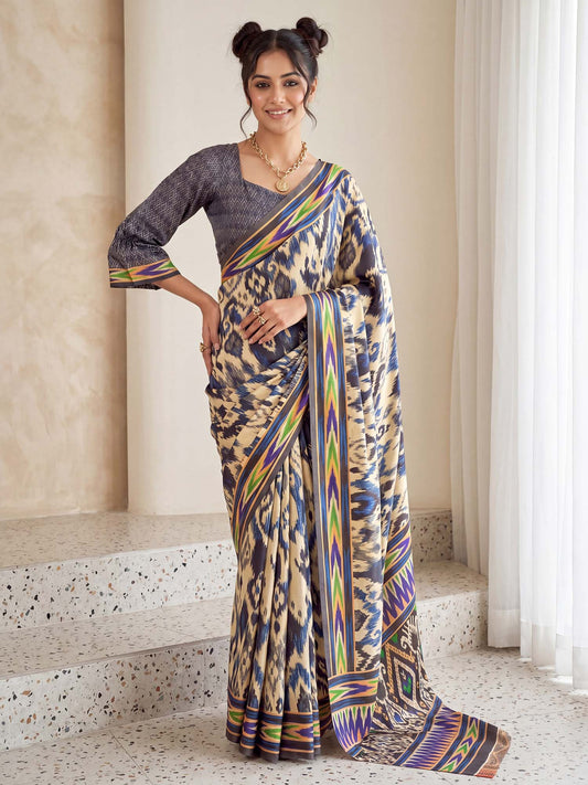 Woman wearing beige crepe saree with ikat resist-dyed pattern and navy blue blouse