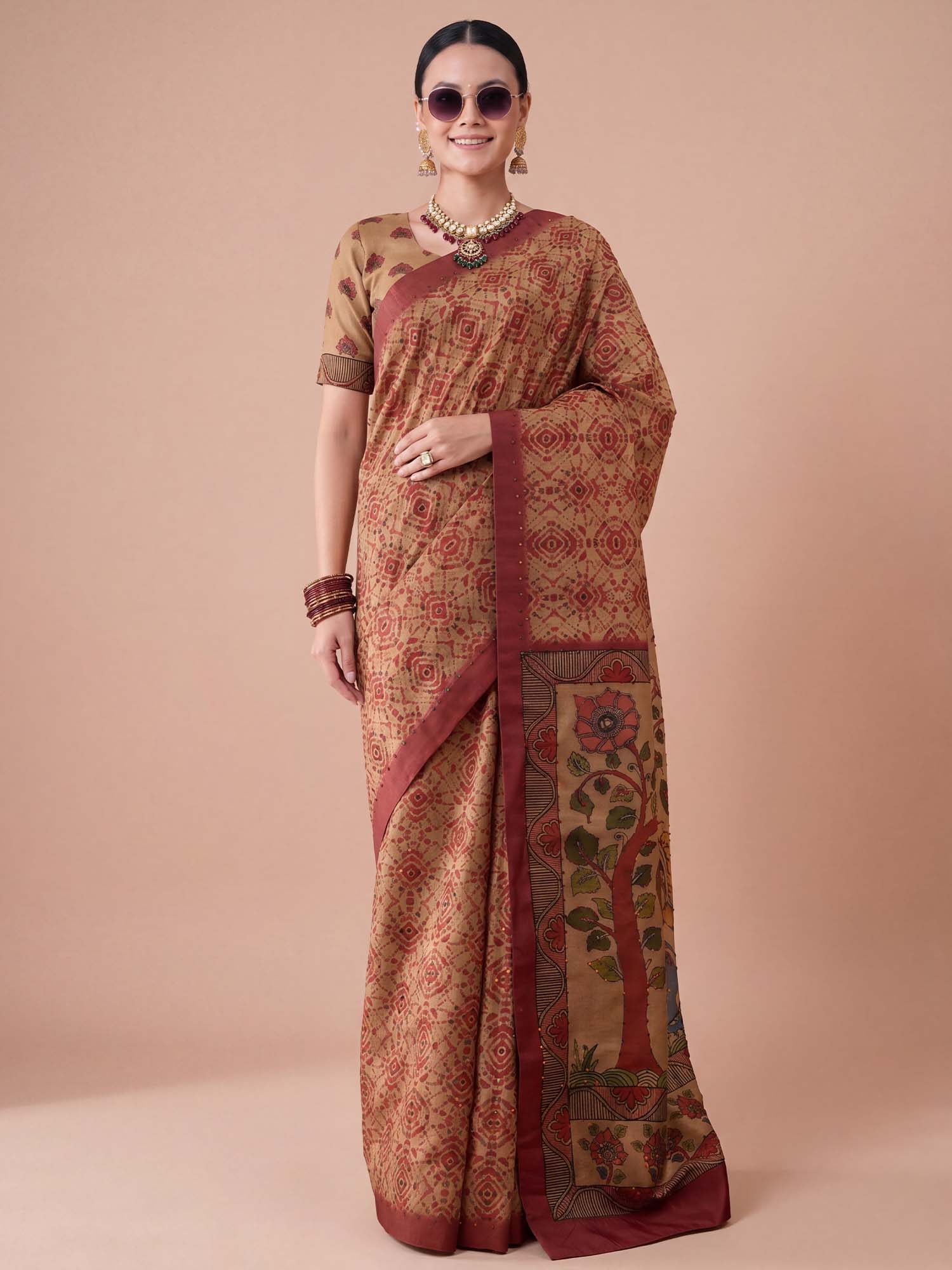 Woman wearing beige silk blend saree with madhubani folk-art motifs and beige blouse