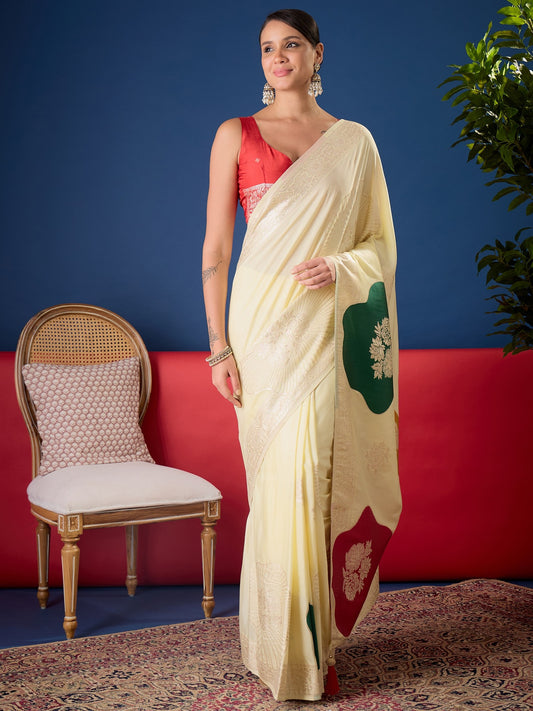 Woman wearing cream dola silk saree with all-over floral design and red blouse