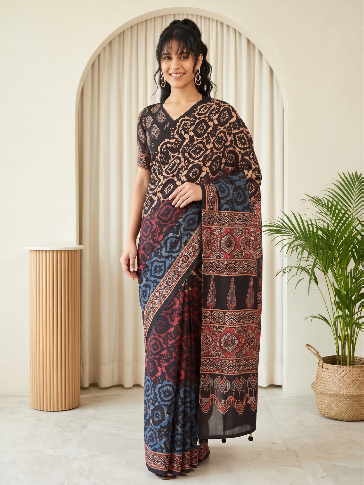 Woman wearing beige silk blend saree with traditional indian motif work and black blouse