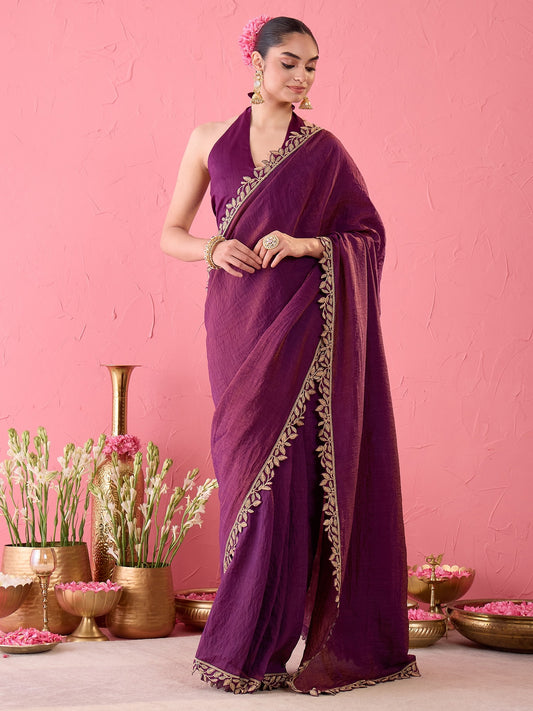 Woman wearing purple silk ready to wear saree with ornamented surface design and purple blouse