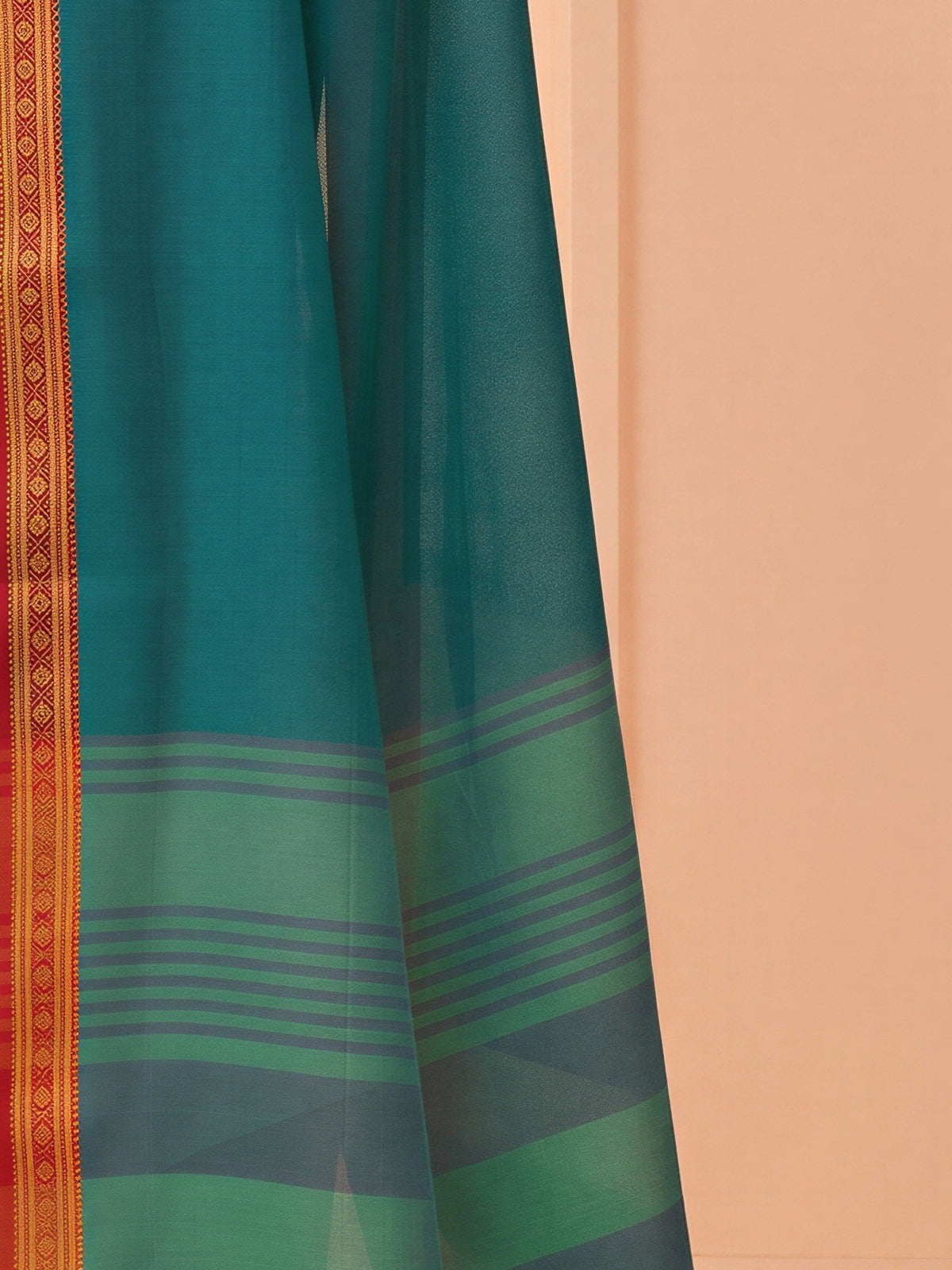 Pallu detail of teal blue cotton blend saree showing clean solid-tone finish and zari border