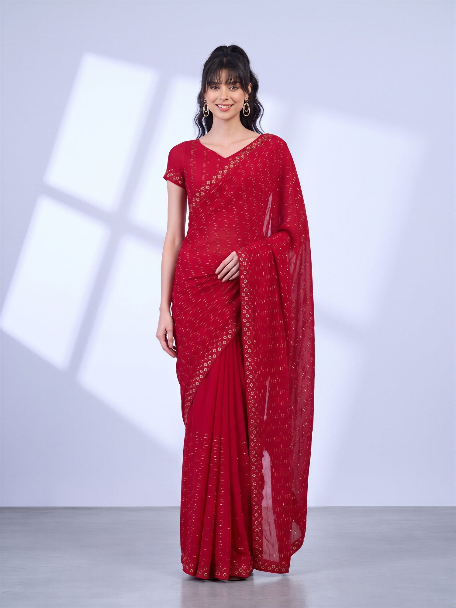 Woman wearing red tissue saree with geometric pattern design and red blouse