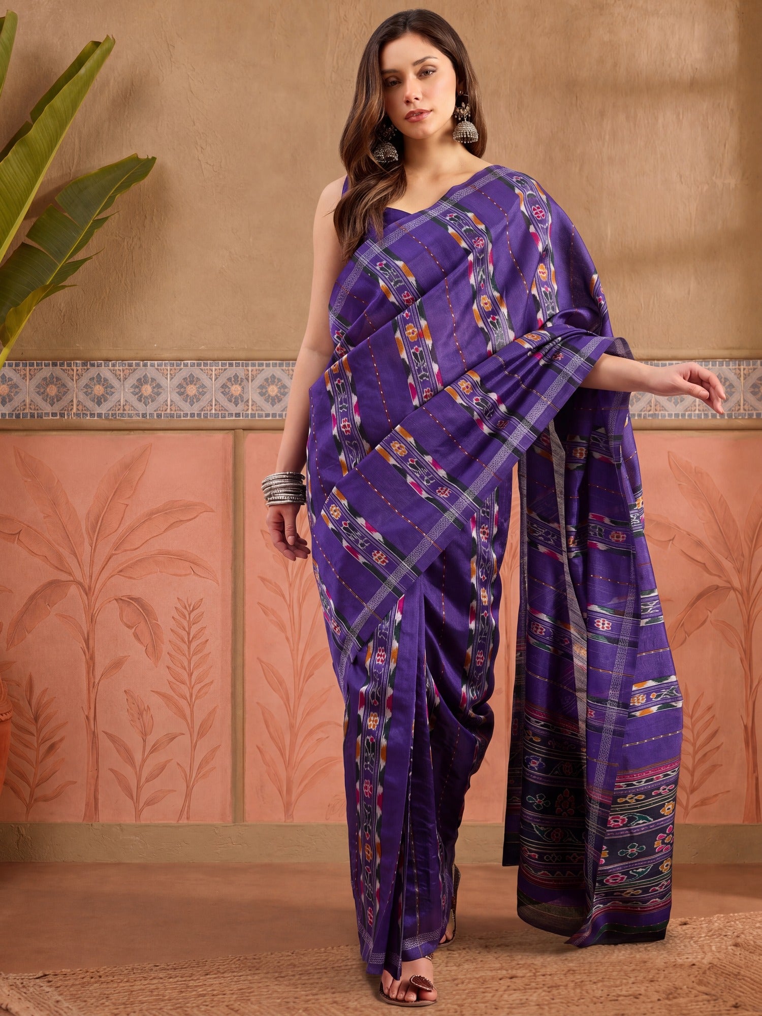 Woman wearing purple bhagalpuri silk saree with ikat resist-dyed pattern and purple blouse