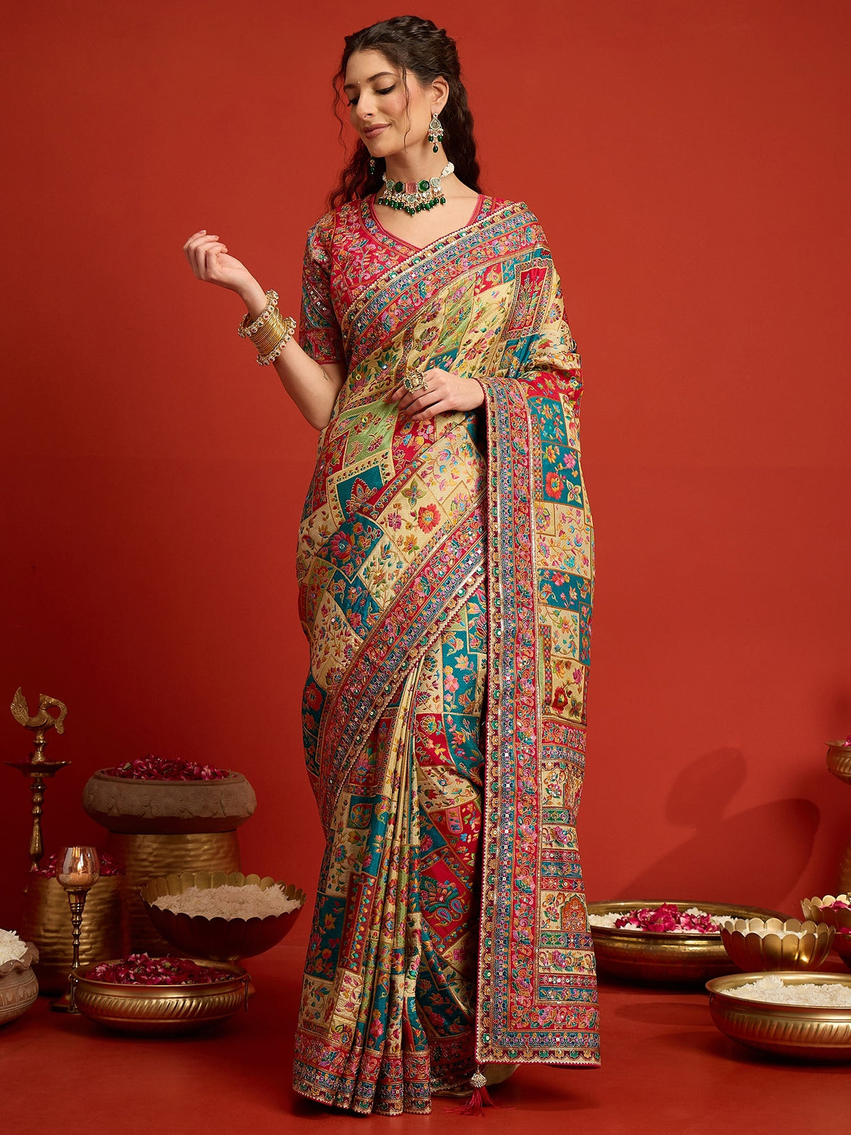 Woman wearing cream silk blend saree with traditional indian motif work and pink blouse