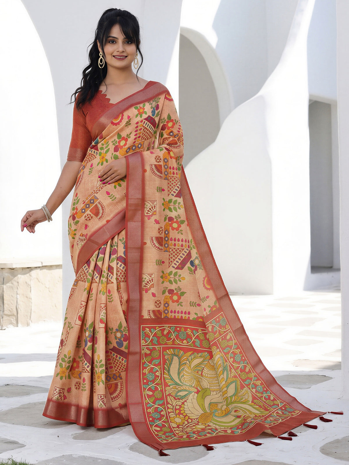 Woman wearing peach cotton silk saree with kalamkari narrative motif work and rust blouse