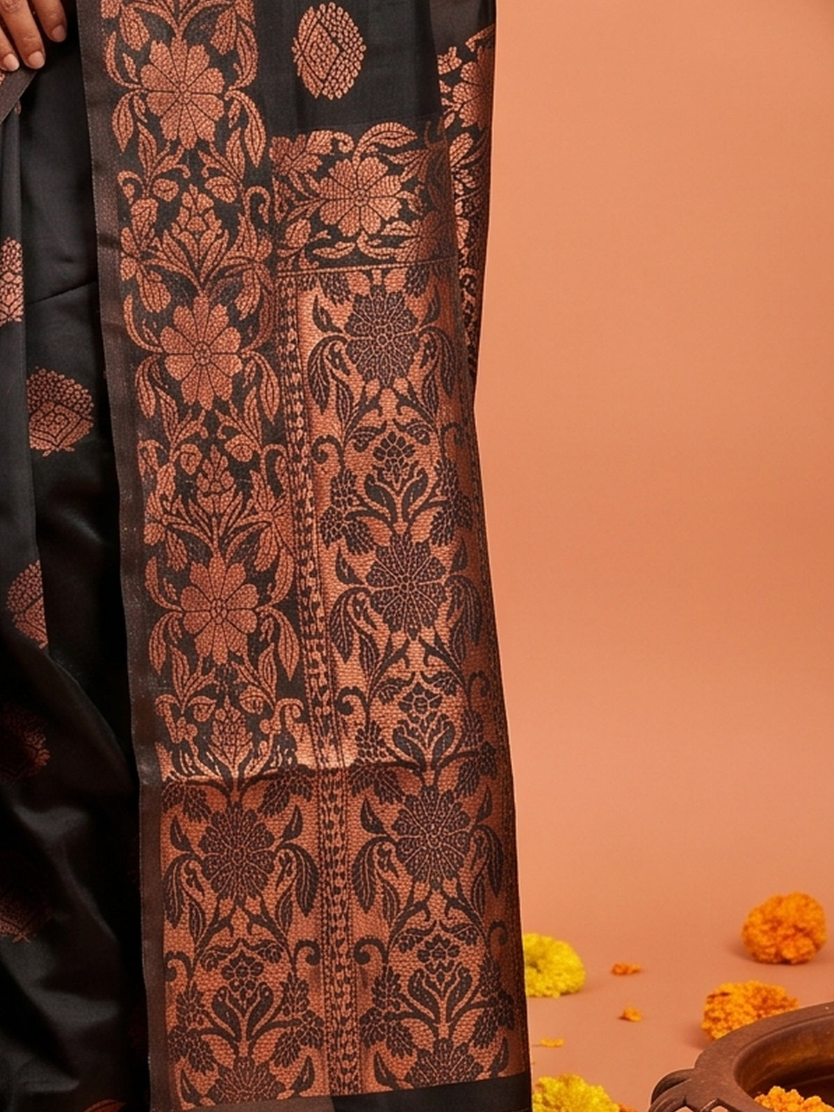 Pallu detail of black silk blend saree showing zari butta (metallic motif) work and zari border