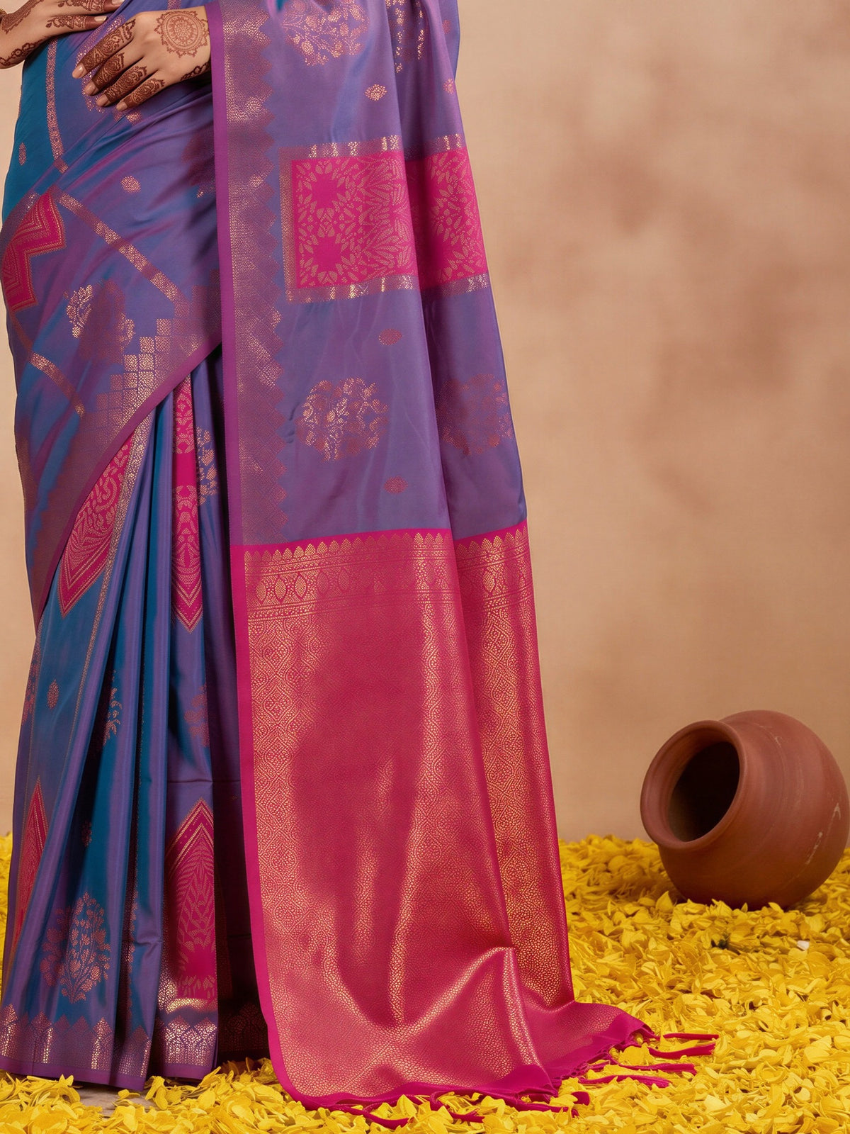 Pallu detail of blue silk saree showing traditional indian motif work and zari border