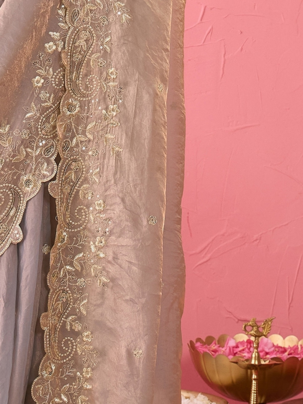 Pallu detail of metallic satin saree showing ornamented surface design and embellished border