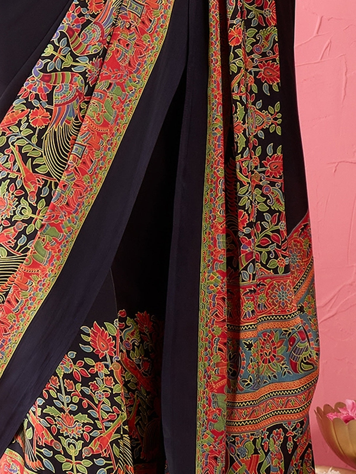 Pallu detail of black satin saree showing madhubani folk-art motifs and printed border