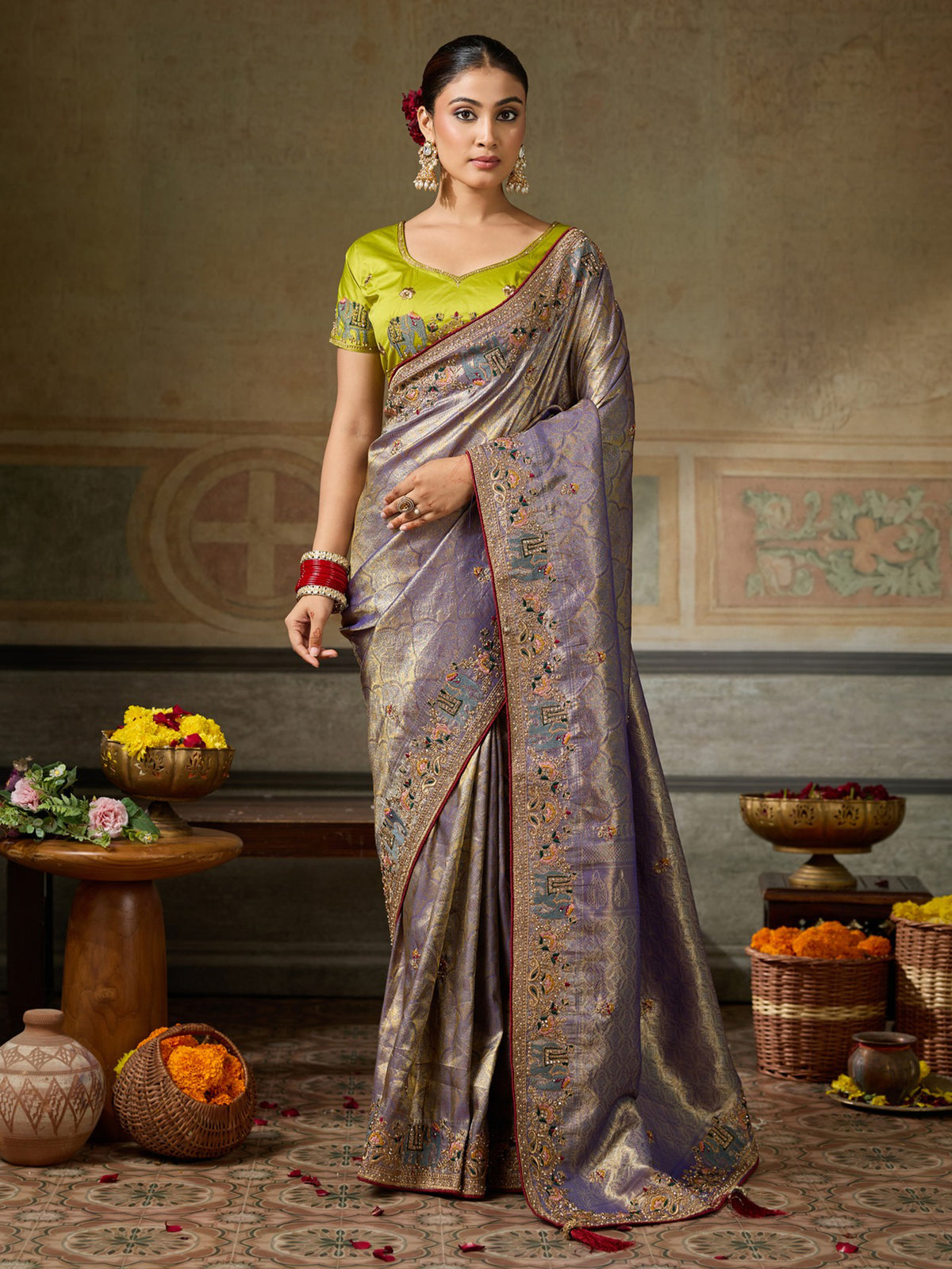 Woman wearing lavender silk blend saree with ornamented surface design and lime green blouse