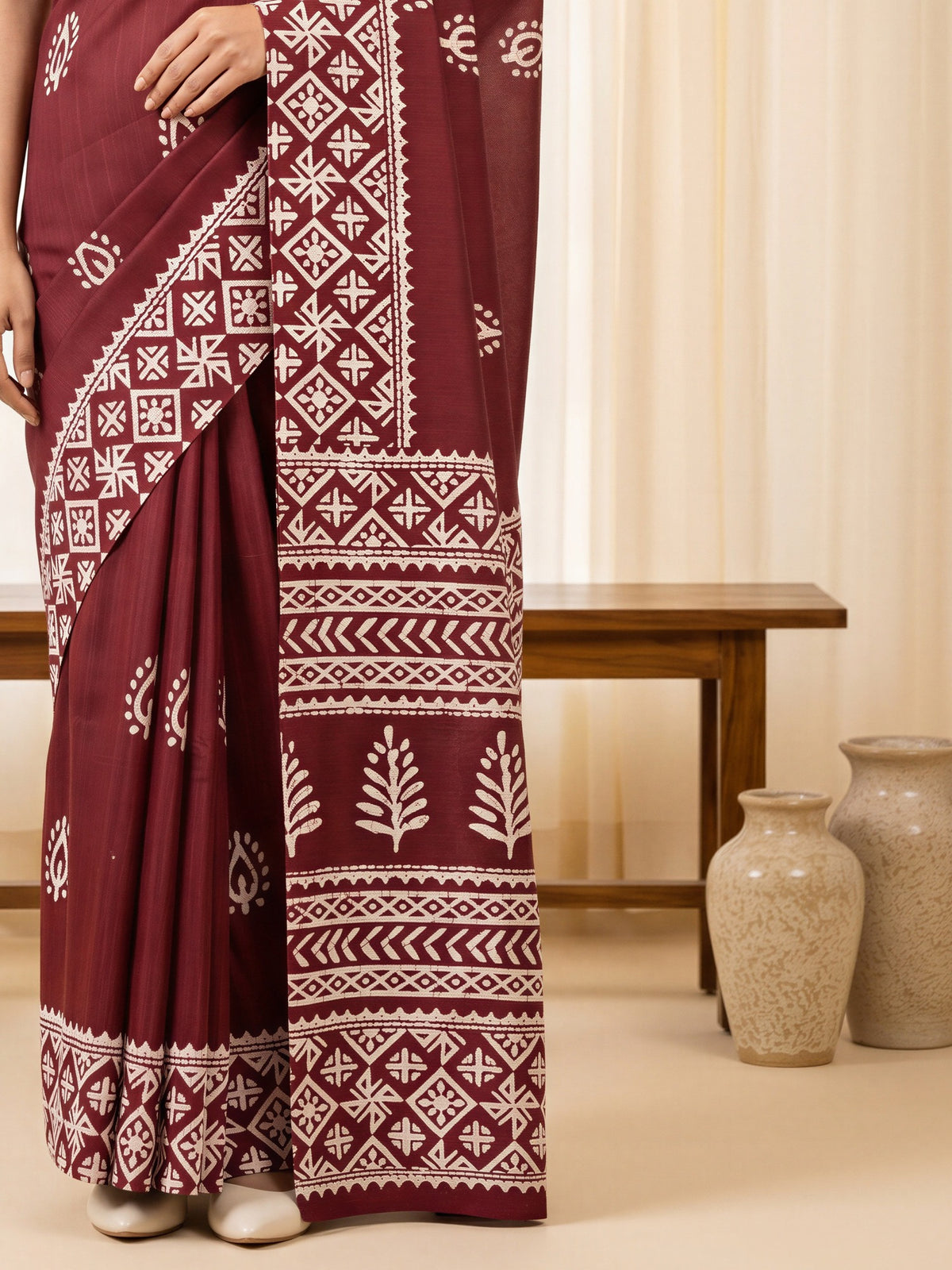 Pallu detail of maroon cotton blend saree showing bagh block-print motif work and printed border
