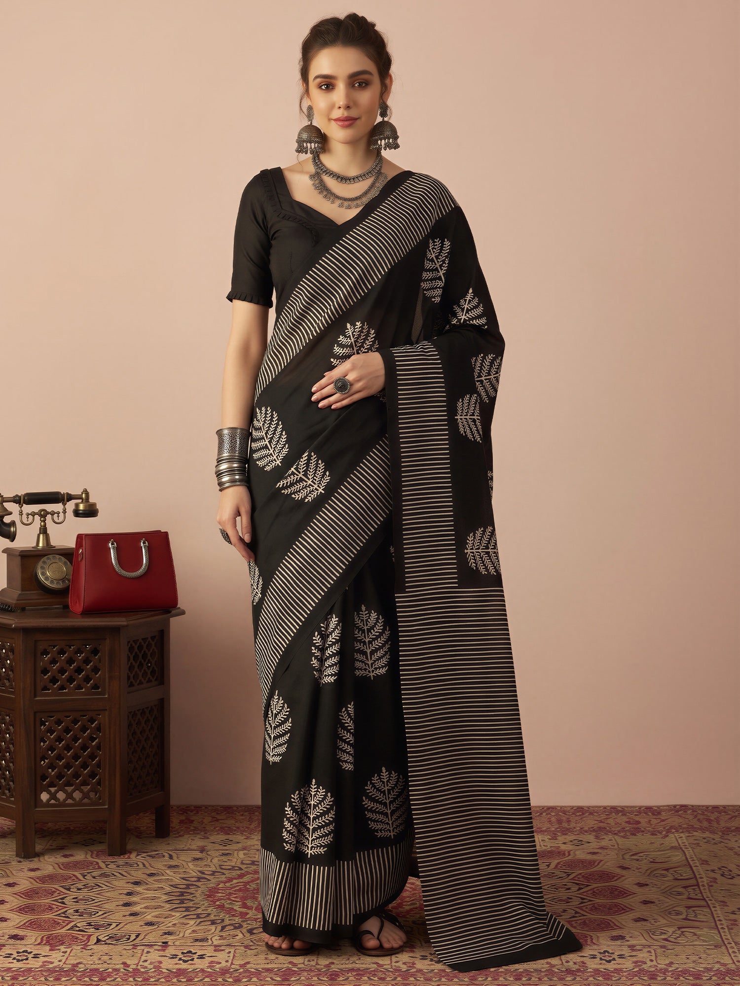 Woman wearing black bhagalpuri silk saree with hand block-printed motifs and black blouse
