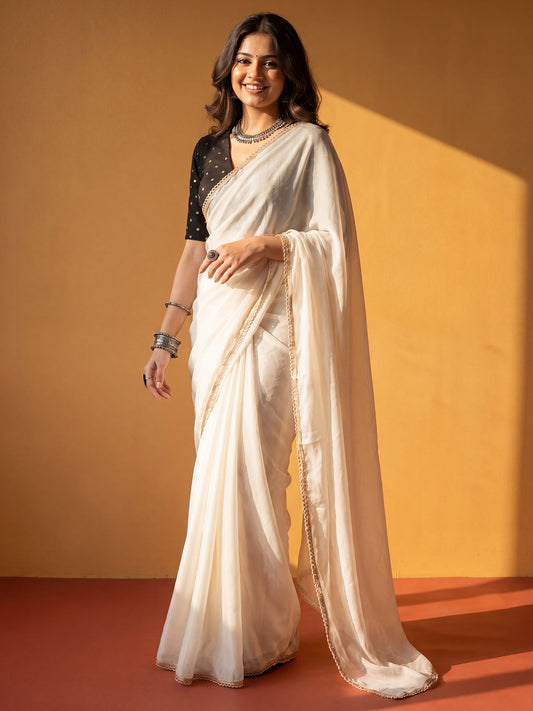 Woman wearing white georgette saree with clean solid-tone finish and white blouse