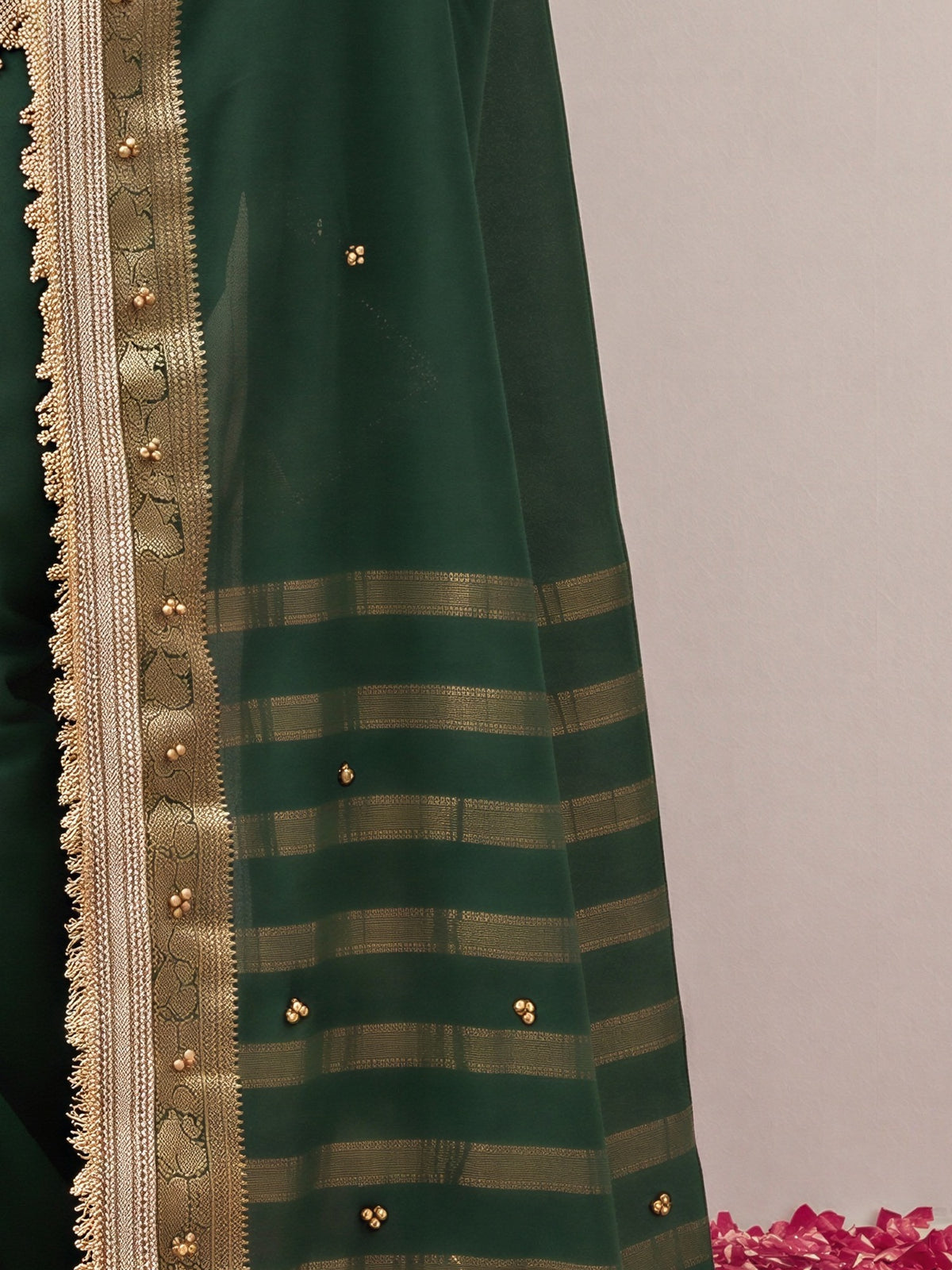 Pallu detail of green soft silk saree showing woven motif design and zari border