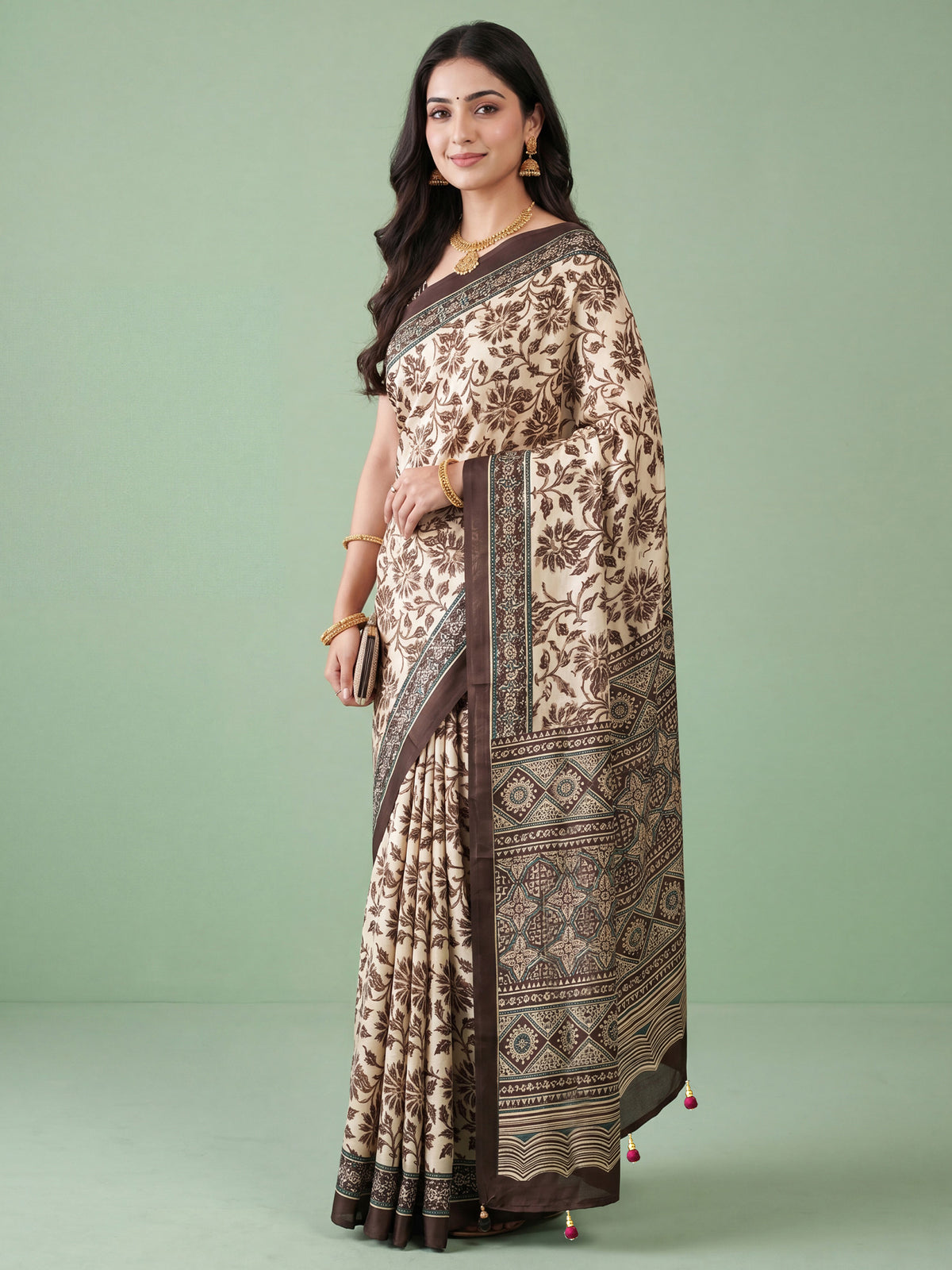 Woman wearing cream satin saree with ajrak block-print motif work and brown blouse