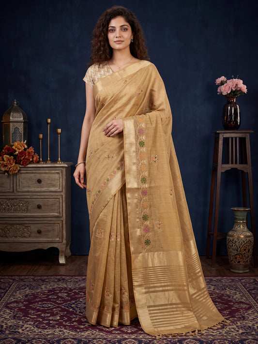 Woman wearing beige cotton linen saree with embroidered motif work and beige blouse
