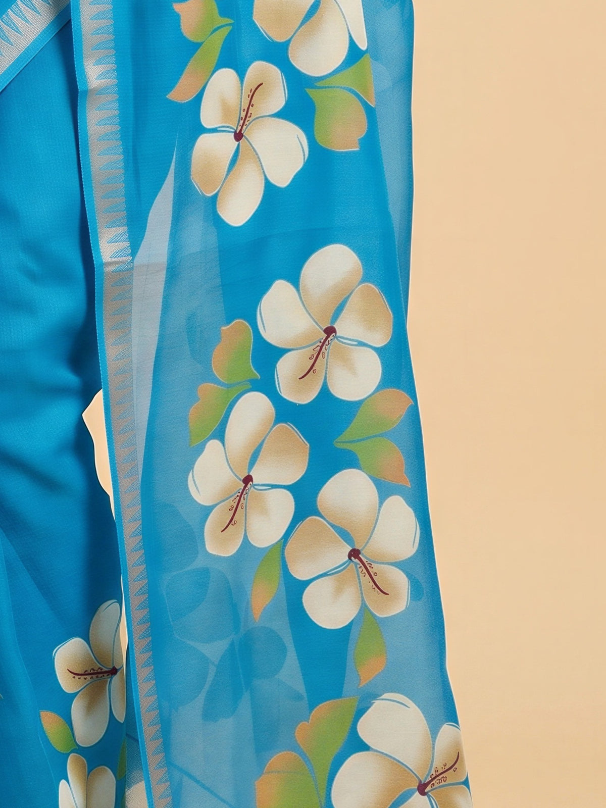 Pallu detail of turquoise blue georgette saree showing all-over floral design and zari border