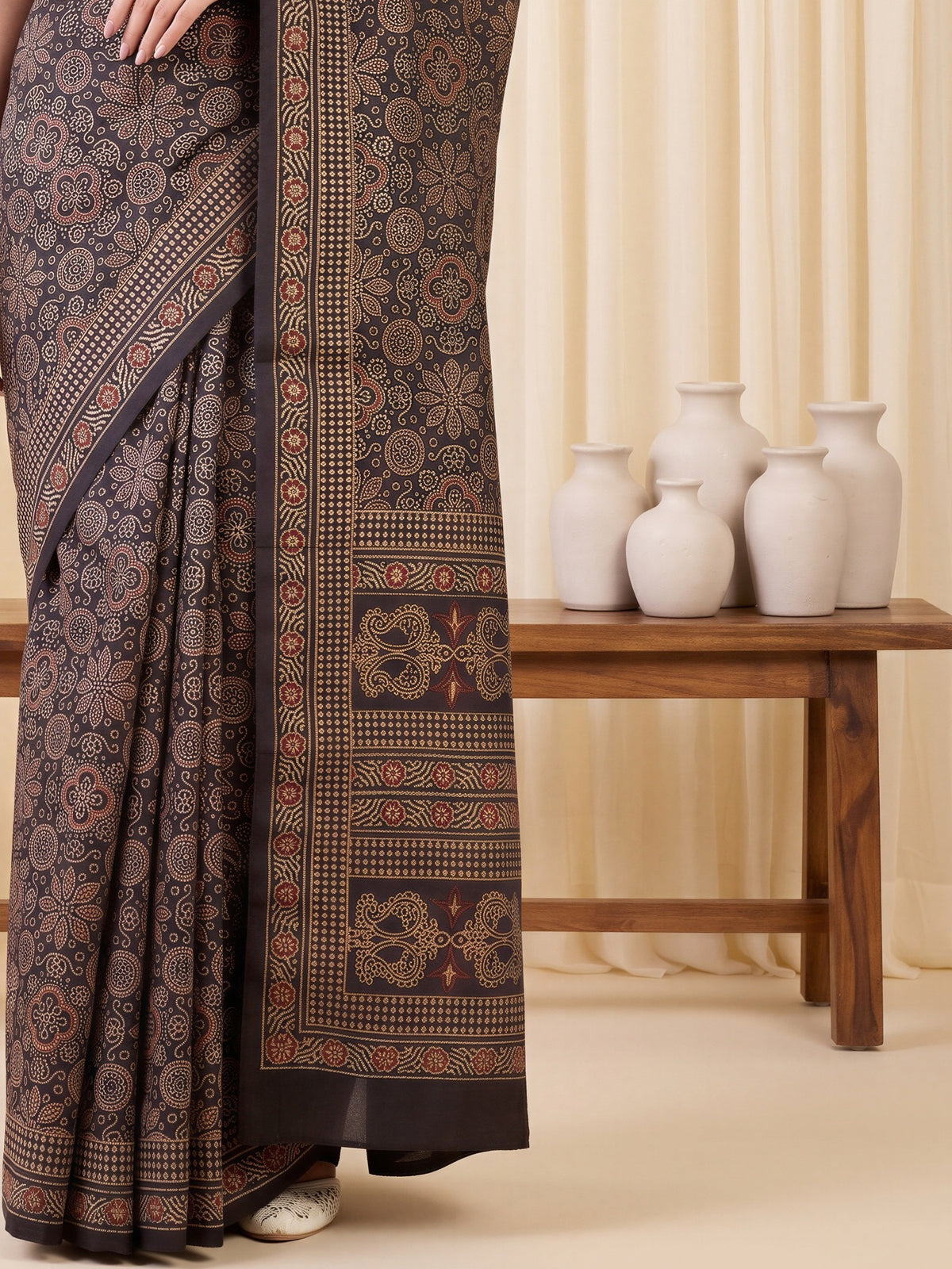 Pallu detail of coffee brown silk blend saree showing ajrak block-print motif work and embellished border