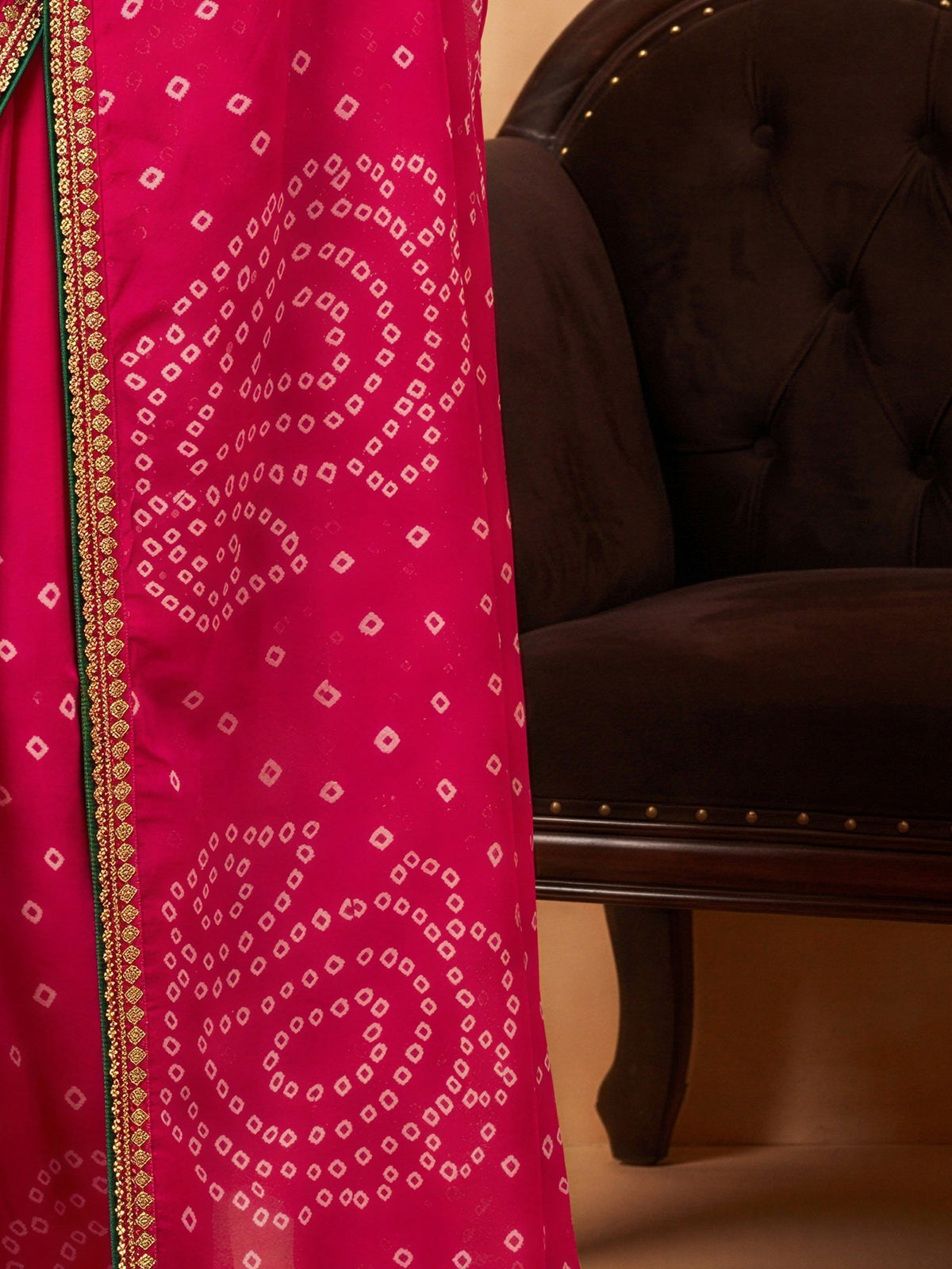 Pallu detail of pink georgette saree showing bandhani tie-dye dot work and embellished border