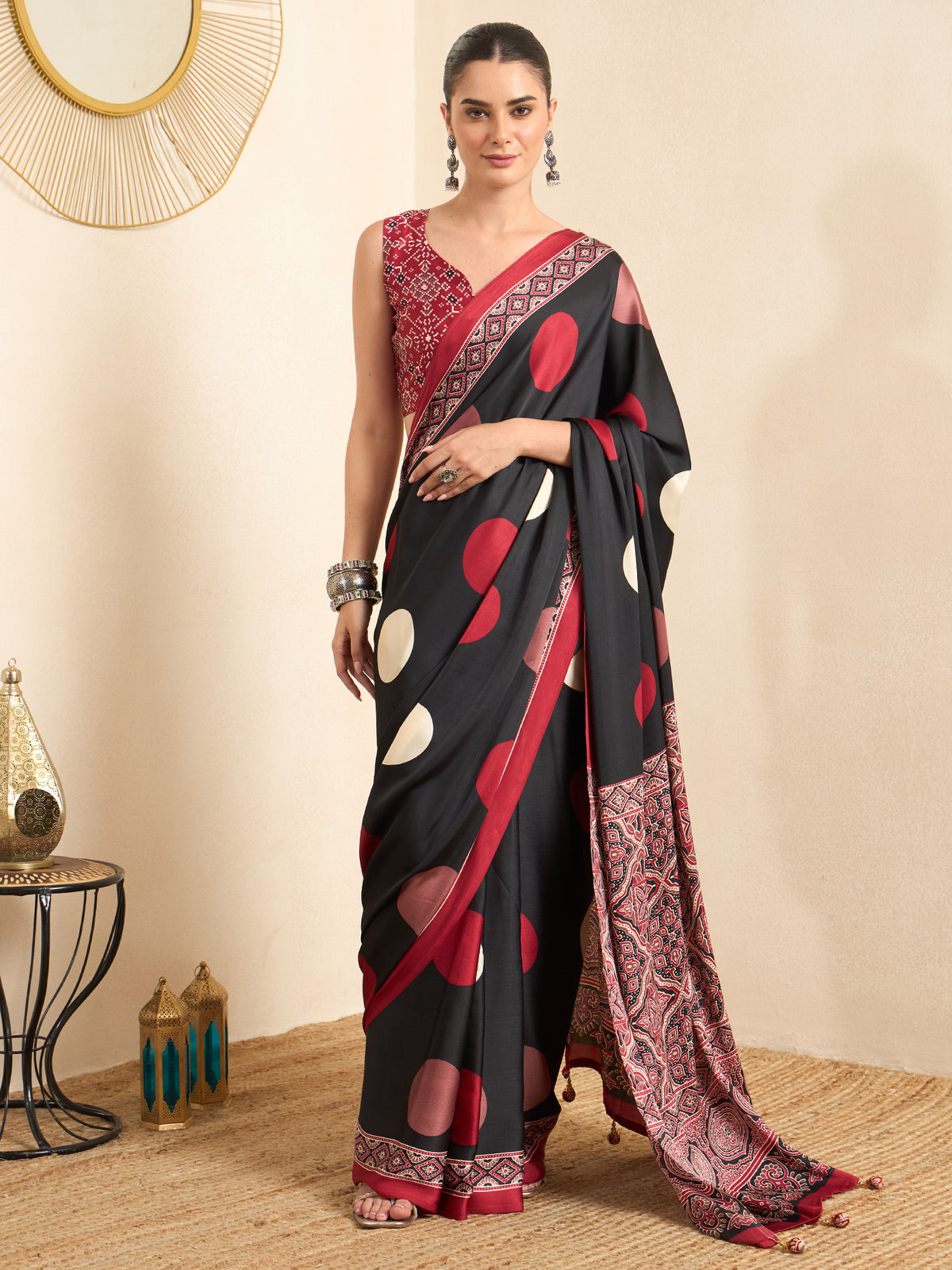 Woman wearing black crepe saree with ajrak block-print motif work and red blouse