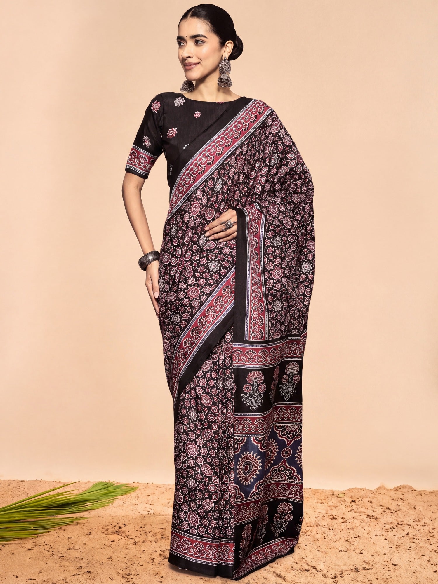 Woman wearing black dola silk saree with ajrak block-print motif work and black blouse