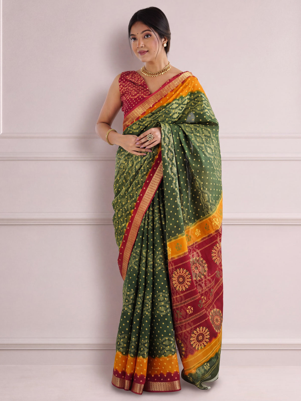 Woman wearing green cotton saree with bandhani tie-dye dot work and red blouse