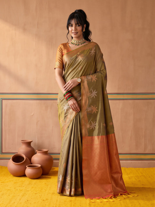Woman wearing light green tussar silk saree with traditional indian motif work and orange blouse