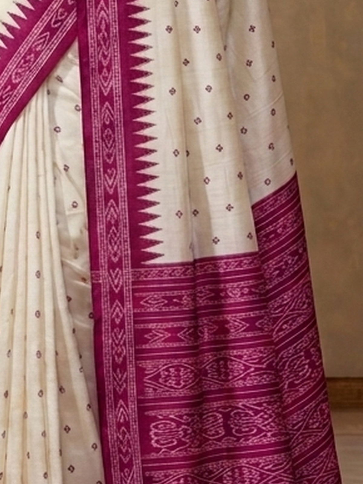 Pallu detail of off white tussar silk saree showing traditional indian motif work and printed border