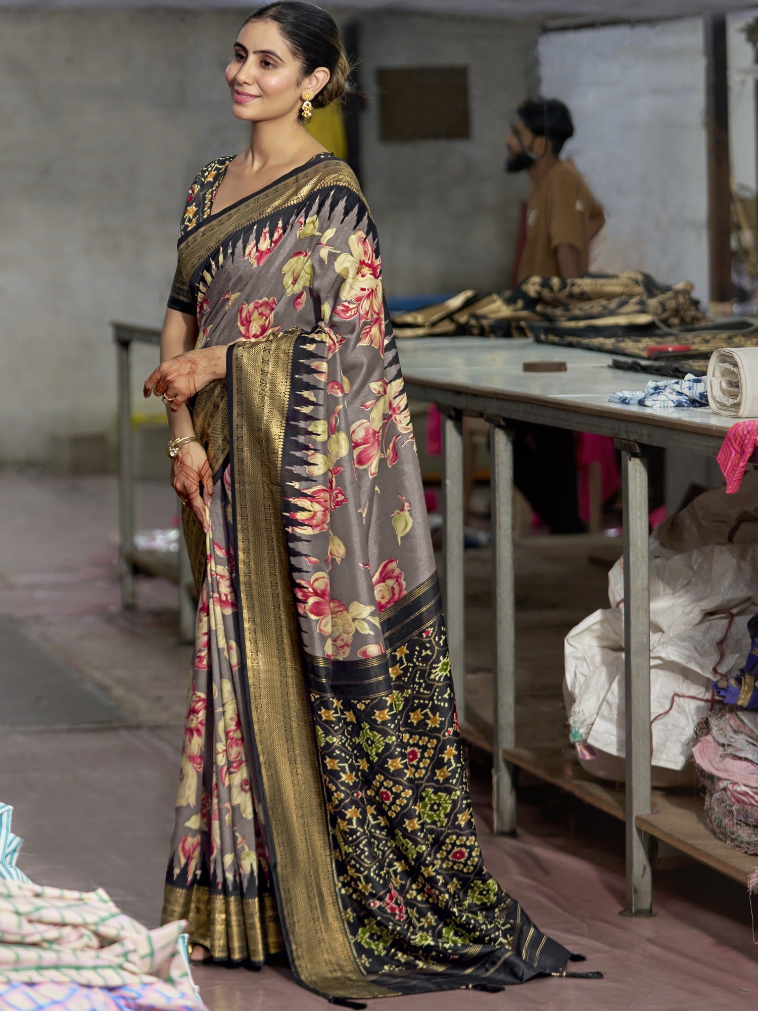 Woman wearing grey tussar silk saree with ikat resist-dyed pattern and black blouse