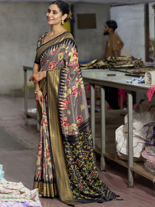 Woman wearing grey tussar silk saree with ikat resist-dyed pattern and black blouse