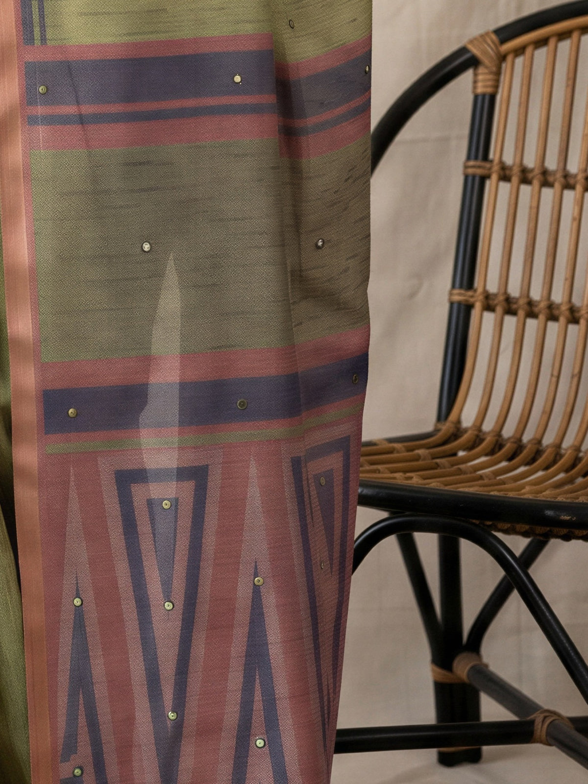Pallu detail of olive linen blend saree showing geometric pattern design and printed border