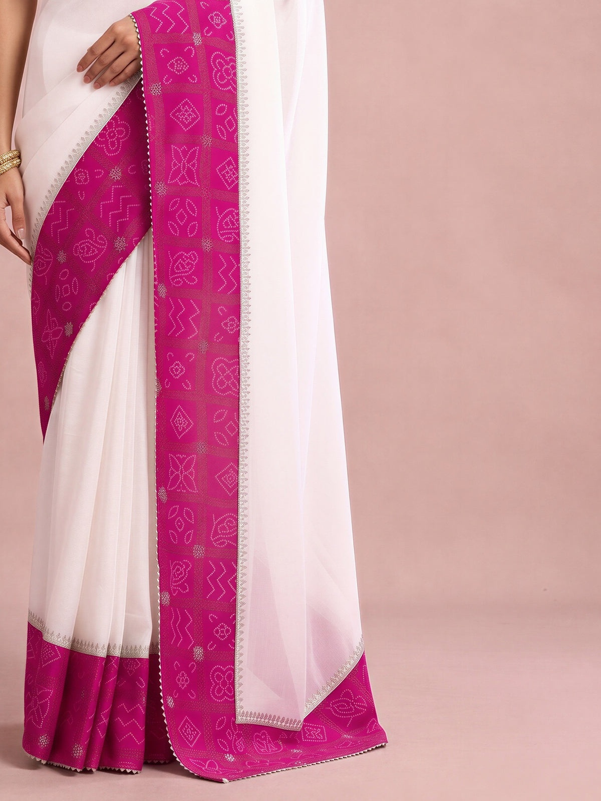 Pallu detail of white vichitra silk saree showing bandhani tie-dye dot work and embellished border